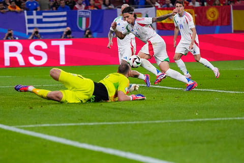 Italy's Riccardo Calafiori (5) scores an own goal 